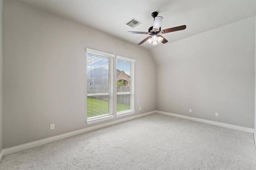 This bedroom features its own ensuite full bathroom for added privacy and convenience.