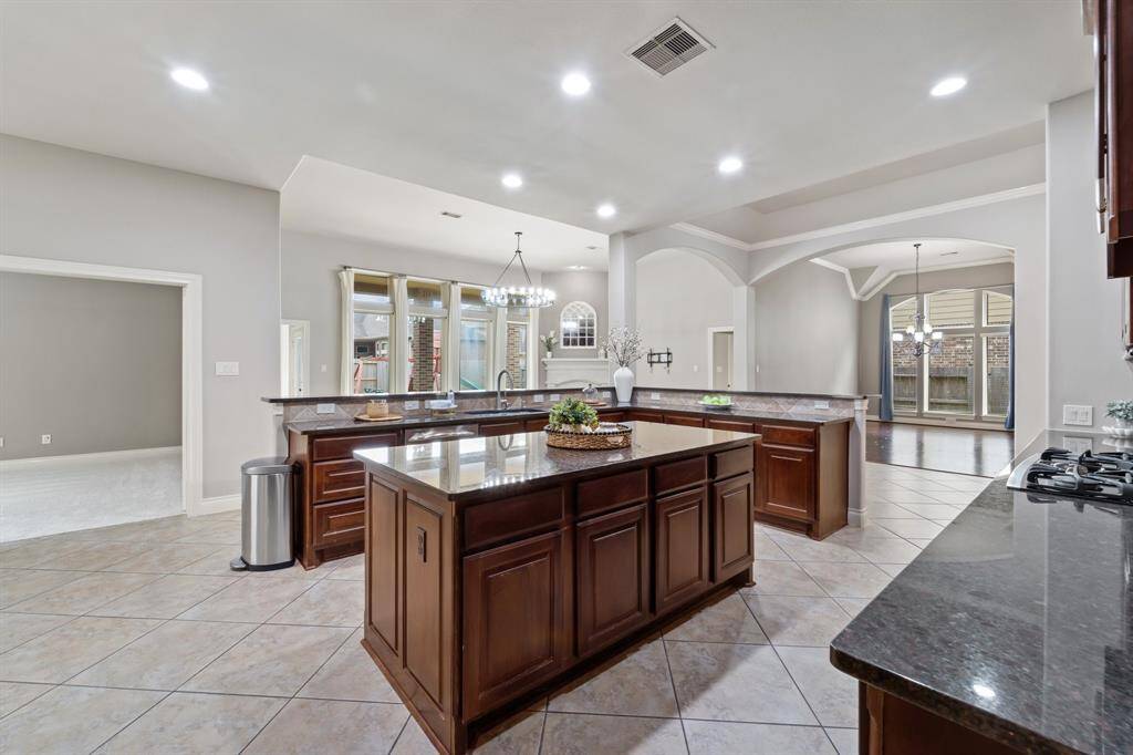 Spacious beautiful kitchen featuring granite countertops and a large central island perfect for meal prep and gatherings.Designed for both functionality and style, ideal for everyday living and entertaining.