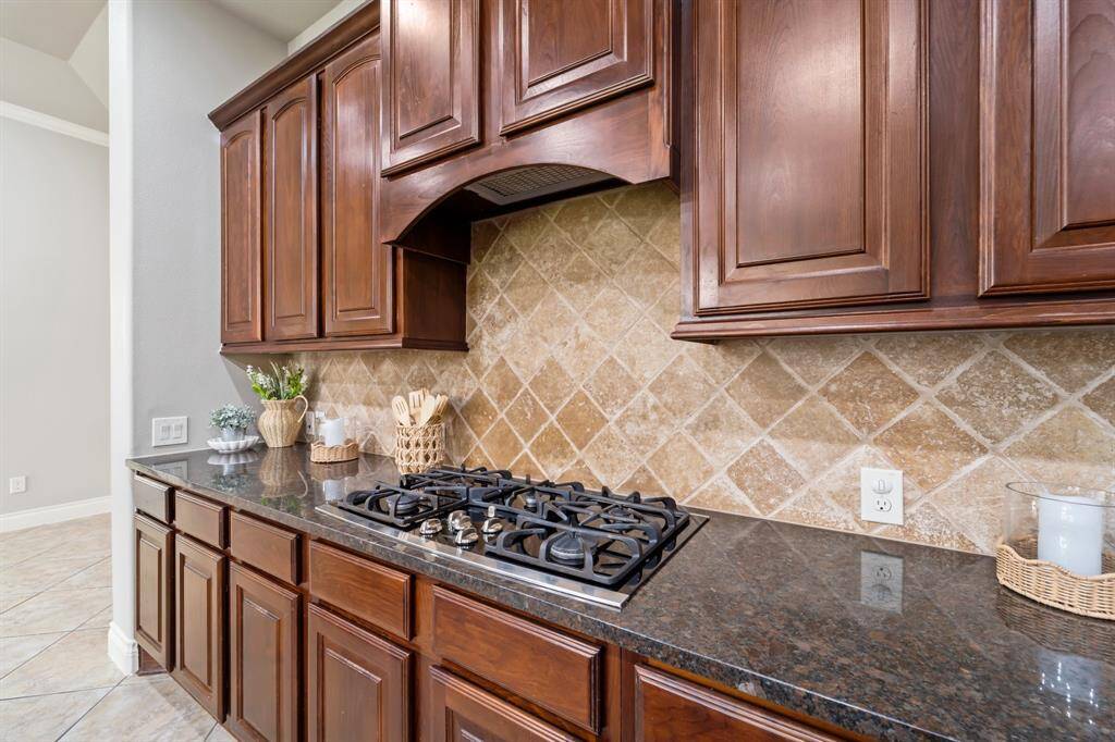 The kitchen boasts a premium 5-burner stove, perfect for cooking multiple dishes with ease.