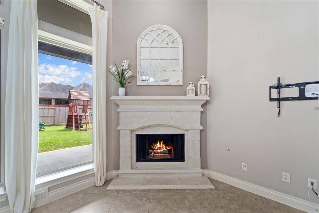 The living room features a cozy wood-burning fireplace and gas connections for versatile heating options