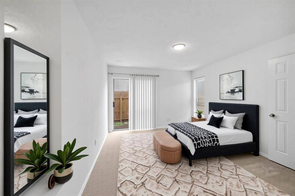 Master Bedroom with Sliding glass door to the back yard. virtually staged