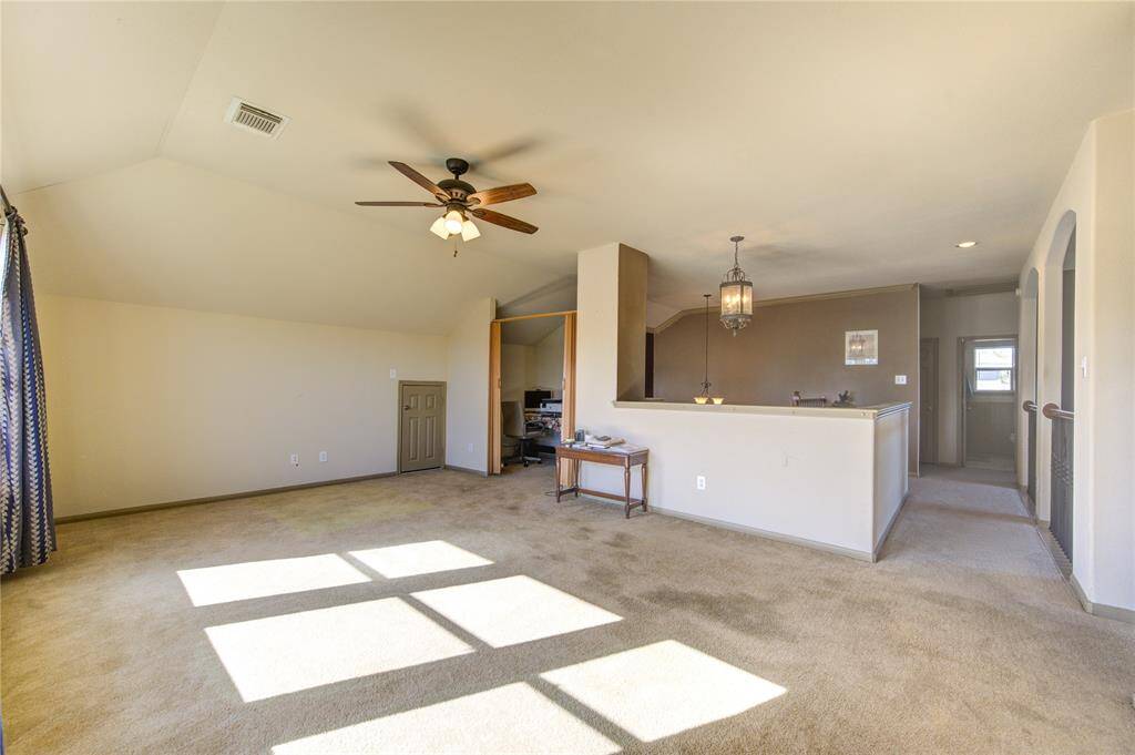Large upstairs game room with natural light including a nook office space