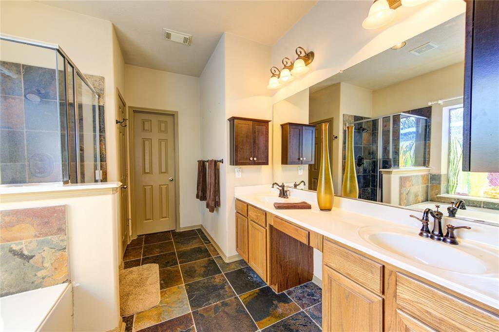 Awesome primary bathroom with 2 sinks, natural light, separate tub/shower + a private water closet and a great closet