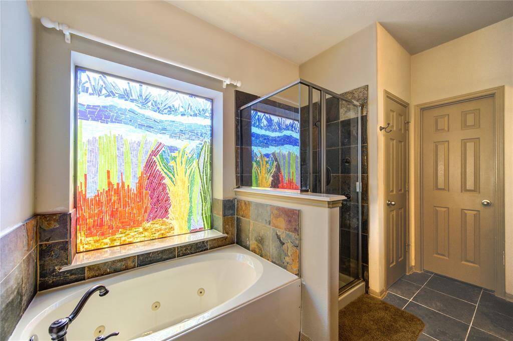 Large primary bathroom with 2 sinks, natural light, separate tub/shower + a private water closet