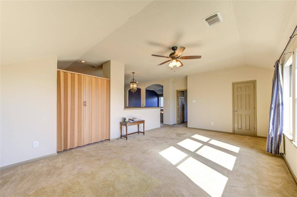 Large upstairs game room with natural light including a nook office space to the left