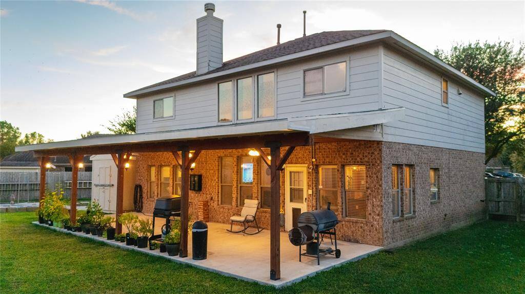 Evening view of the custom 40 foot wide covered patio in the backyard