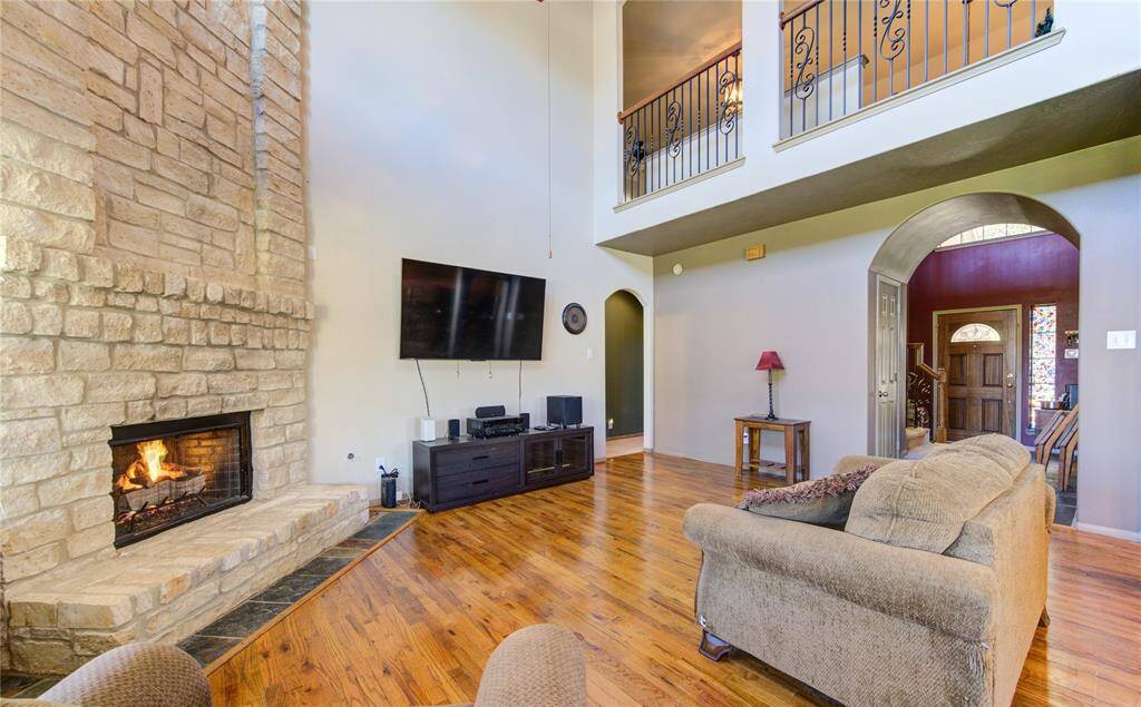 Cozy fireplace with beautiful real wood floors opening the kitchen and living room