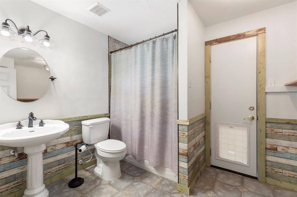 Convenient full bathroom and laundry room with direct pool access.
