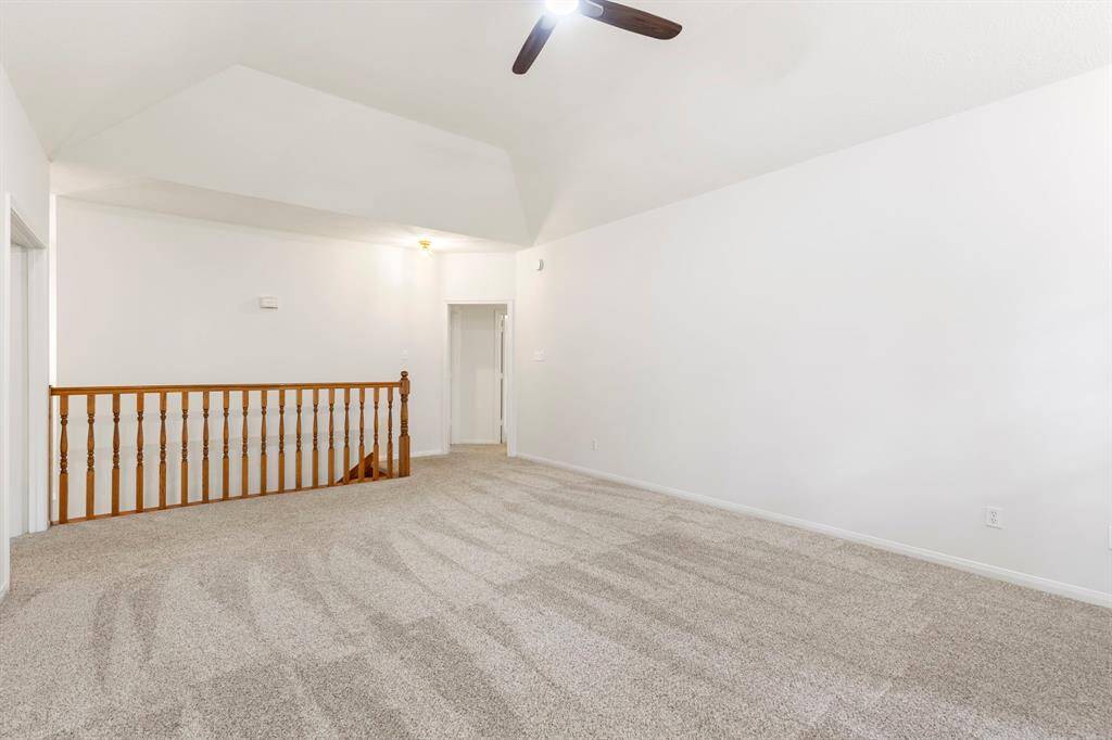 Expansive game room featuring a cozy fireplace, perfect for entertaining.