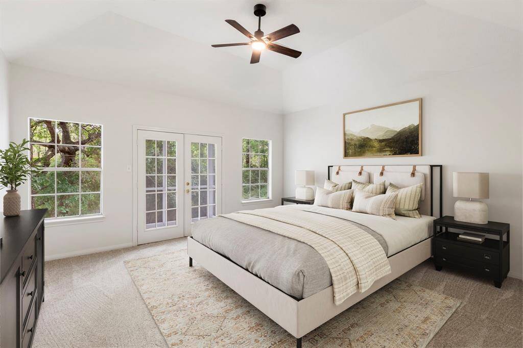 Experience ultimate comfort in this beautifully staged master bedroom, featuring abundant natural light.