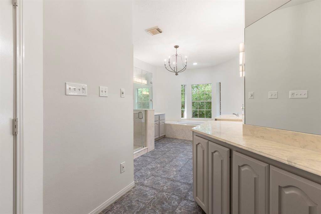 Spacious master bathroom with elegant fixtures and ample natural light.