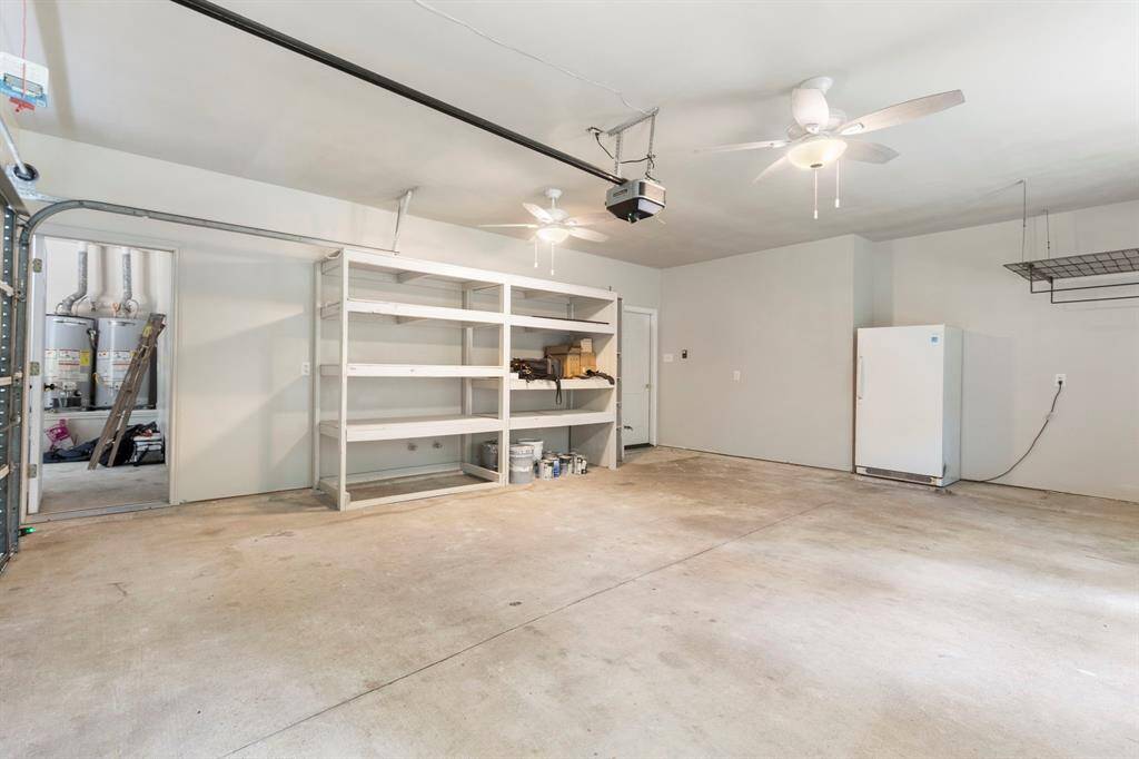 This oversized two-car section of a three-car garage offers ample storage and convenience.