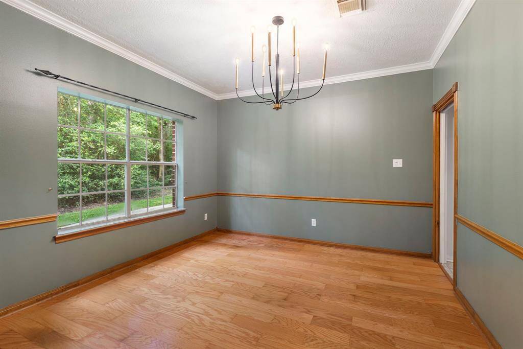 Elegant dining room with large window views and stylish lighting, perfect for hosting.