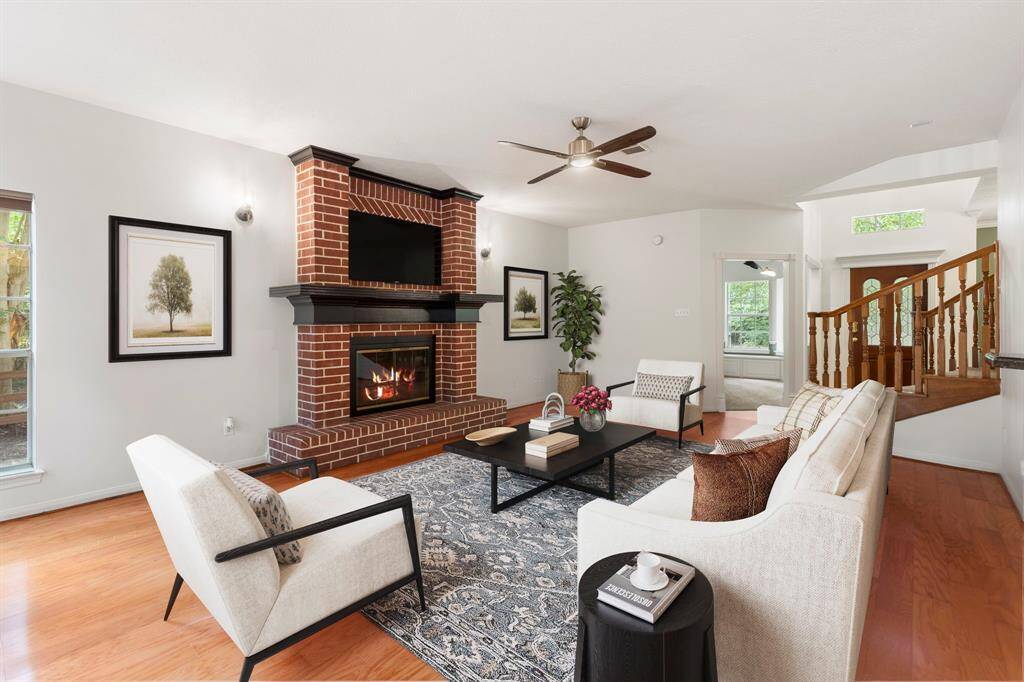 Experience modern elegance in this beautifully AI staged living room, featuring a cozy fireplace, sleek hardwood floors, and abundant natural light. Perfect for relaxation and entertaining.
