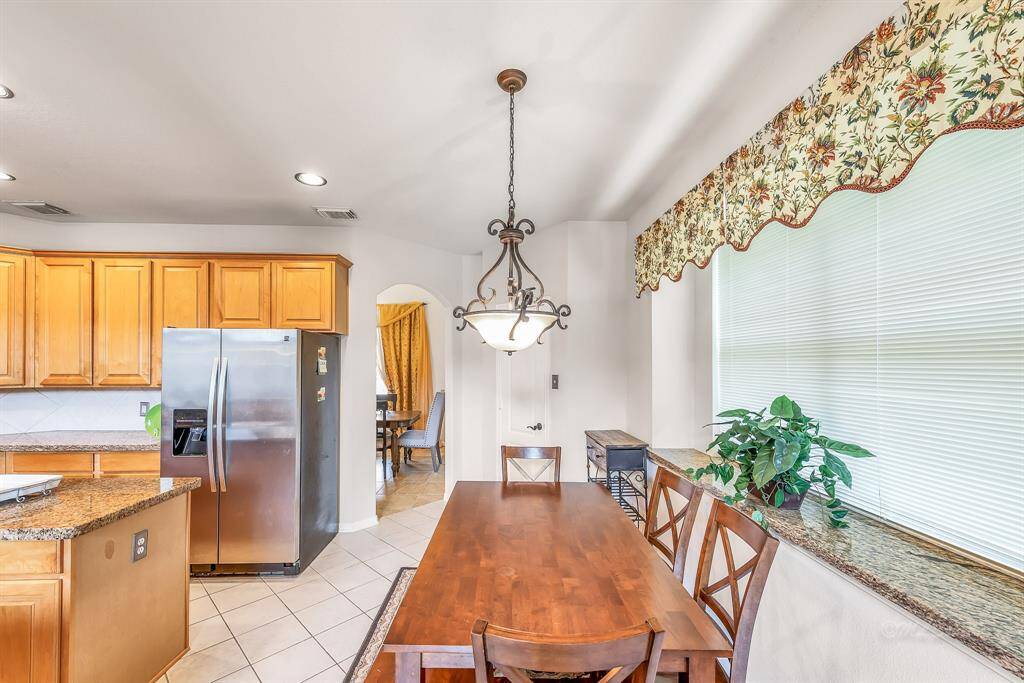 The breakfast room with seating for 6 and granite accents provides a relaxed spot for casual dining.  The granite window sill easily transforms into a serving bar for informal gatherings or family meals.  Large windows provide abundant natural light, while blinds provide privacy if desired.