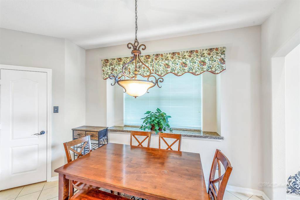 Another view of the breakfast room with pantry to the left and living room to the right.