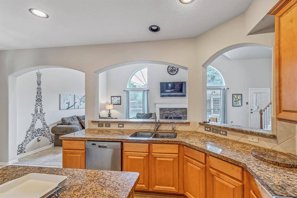 View from the kitchen to the living room and beyond to the covered patio and backyard.