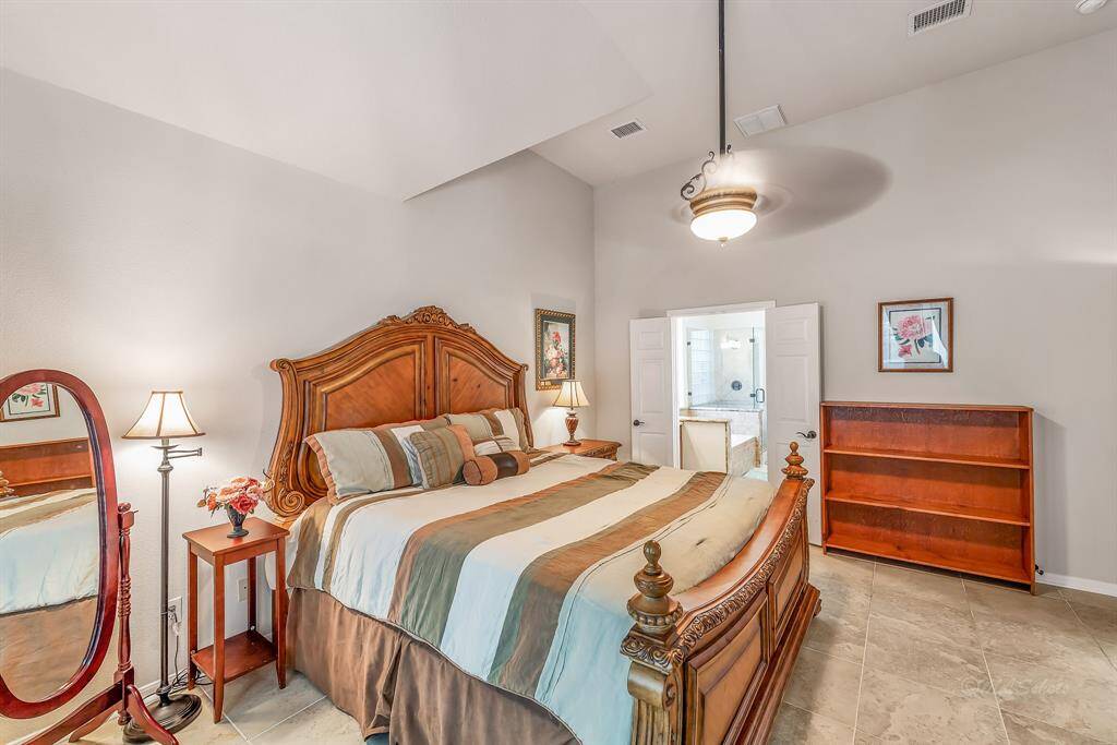 View from the master bedroom toward the master bath. Access to the master bath is through double doors. Neutral paint tones add to the relaxing nature of this space.