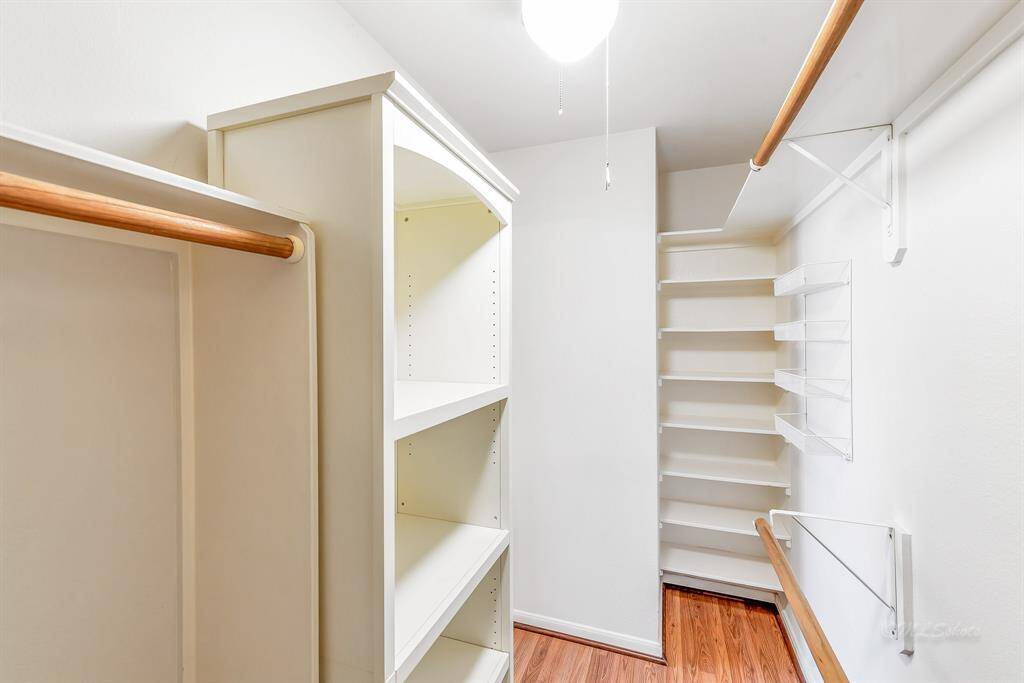 Dual walk-in closets with built-in storage in the master suite.