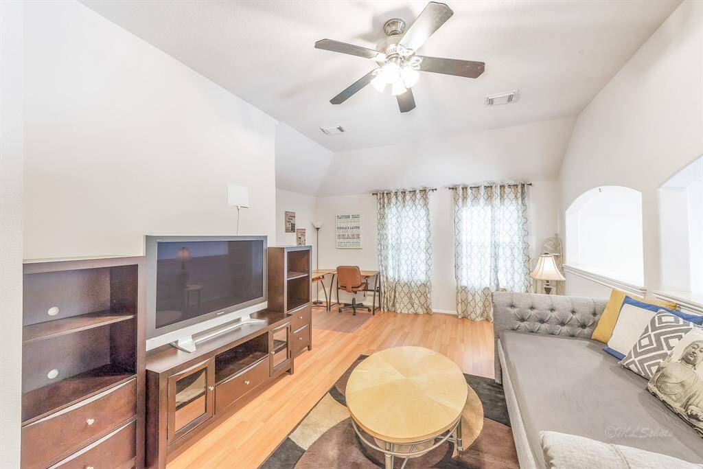 Upstairs gameroom is currently arranged to allow for a TV room/den, with a study nook beyond.
