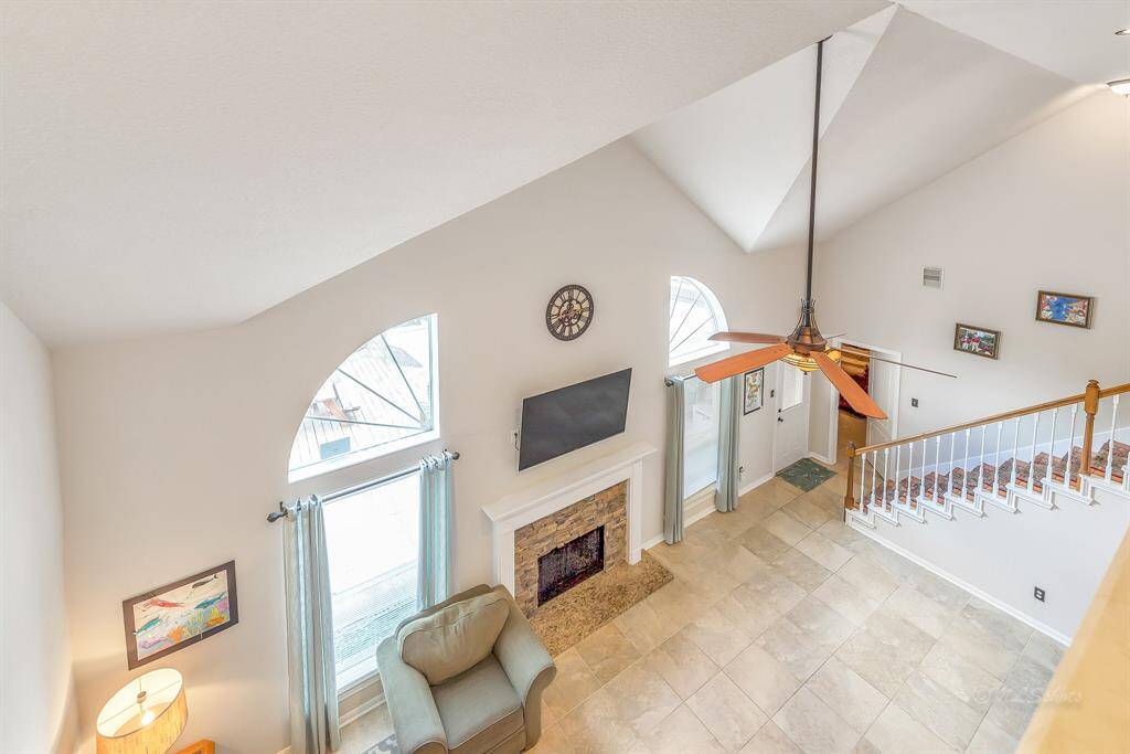 View from the gameroom down to the living room.  The natural light and high ceilings in this home are nothing short of impressive.