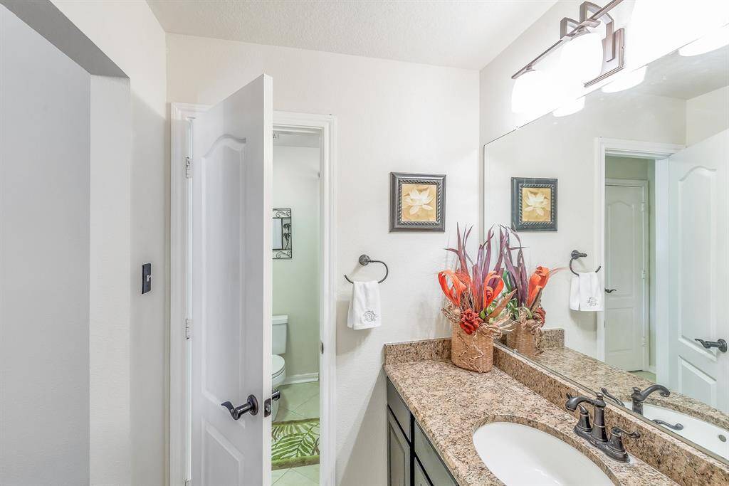 Full bath upstairs features granite countertops and updated fixtures.