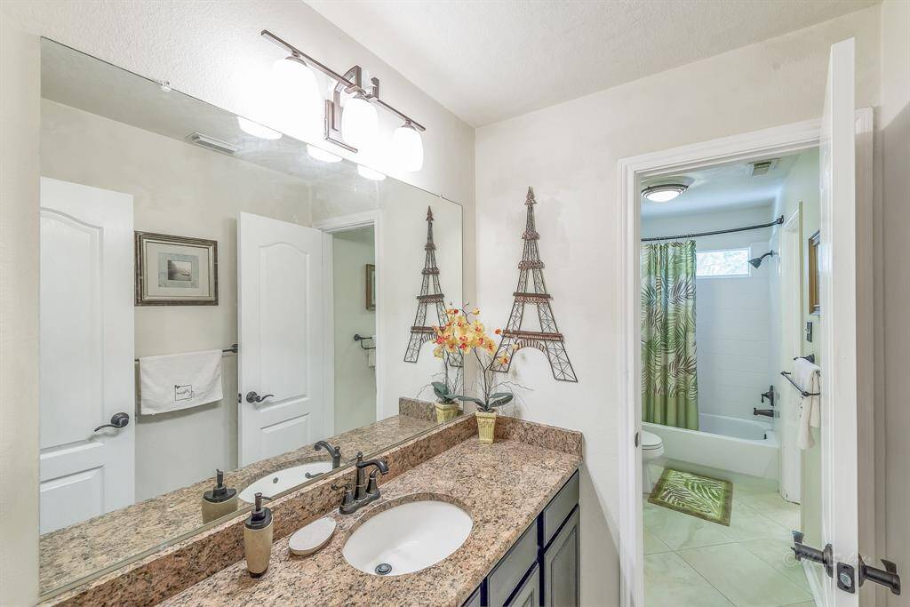 A second sink area for the upstairs bathroom can be accessed from the hallway. Tub and toilet are central to two sink rooms, allowing for easy sharing and privacy.