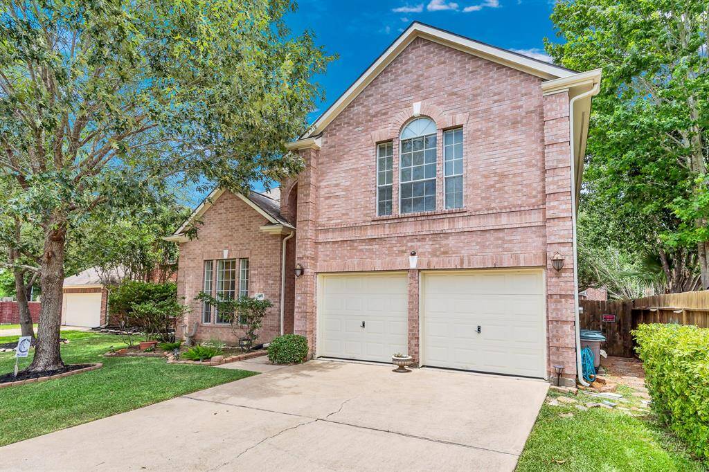 The attached two-car garage with epoxy-coated floor and double-wide driveway allow parking for you and your guests. Storage for trash cans is located on the side of the home, leaving garage floor space open for parking and storage.