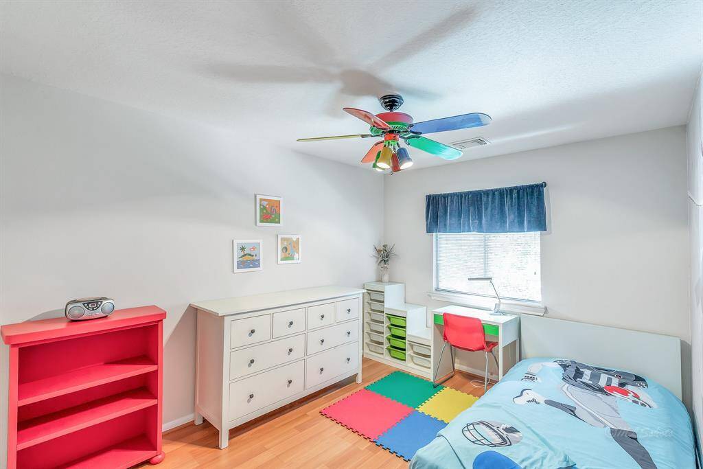 Secondary bedroom upstairs. What a bright and cheery space! This bedroom has views to the side of the home. Twin-sized bed.
