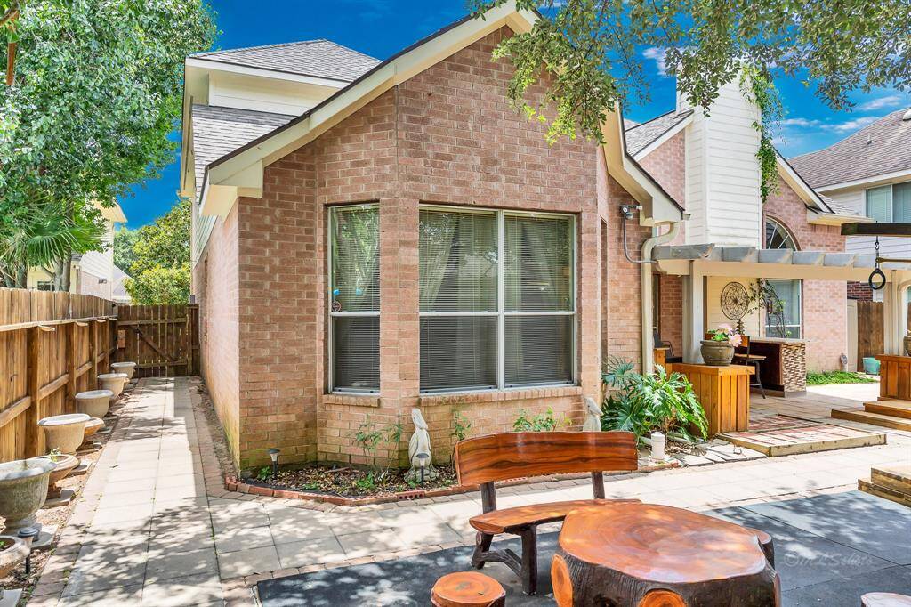 Flowerbeds beneath the bay window of the master bedroom and planters along the fence provide the opportunity to add seasonal color to the yard without requiring extensive maintenance. The seating area is the perfect spot to keep a watchful eye on the playscape.
