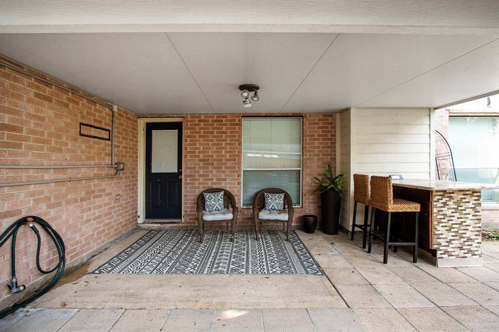 Entertain outdoors with protection from the sun. The granite counter is perfect for serving large groups or for a quiet dinner on the patio.