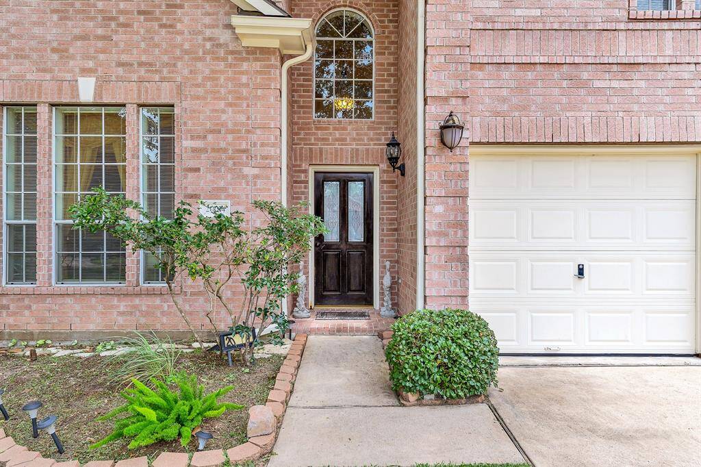 Greet guests under the covered front porch area. Landscape lighting leads the way to your door in the evening.