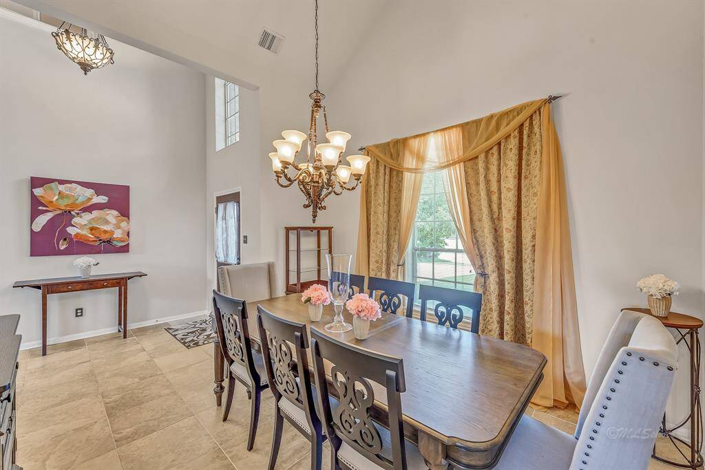 View from the dining room to the front entry of the home. 18-inch tile throughout the entertaining areas of the first floor.