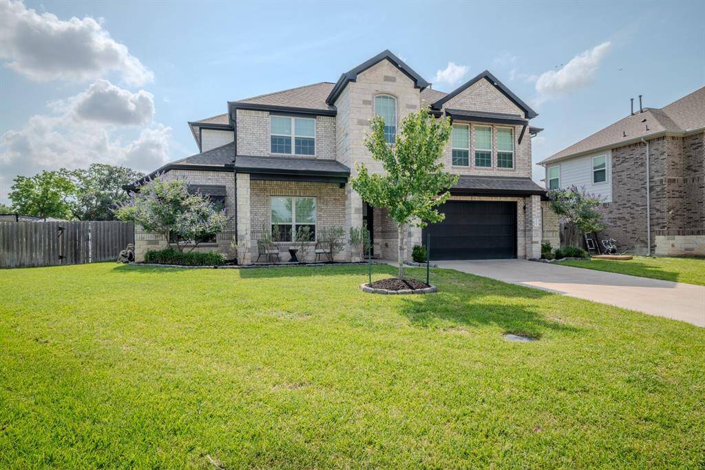 Full brick elevation with front porch and over-sized garage
