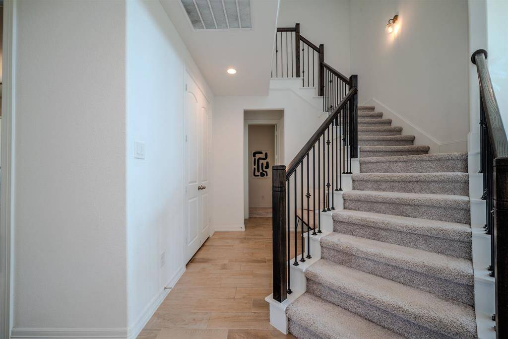 Up the stairs with iron ballisters to the game room and 2 more secondary bedrooms