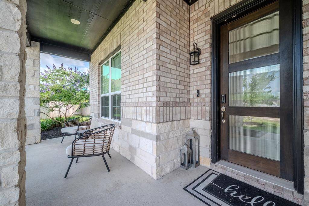 Front porch with seated area and wood and glass entry door