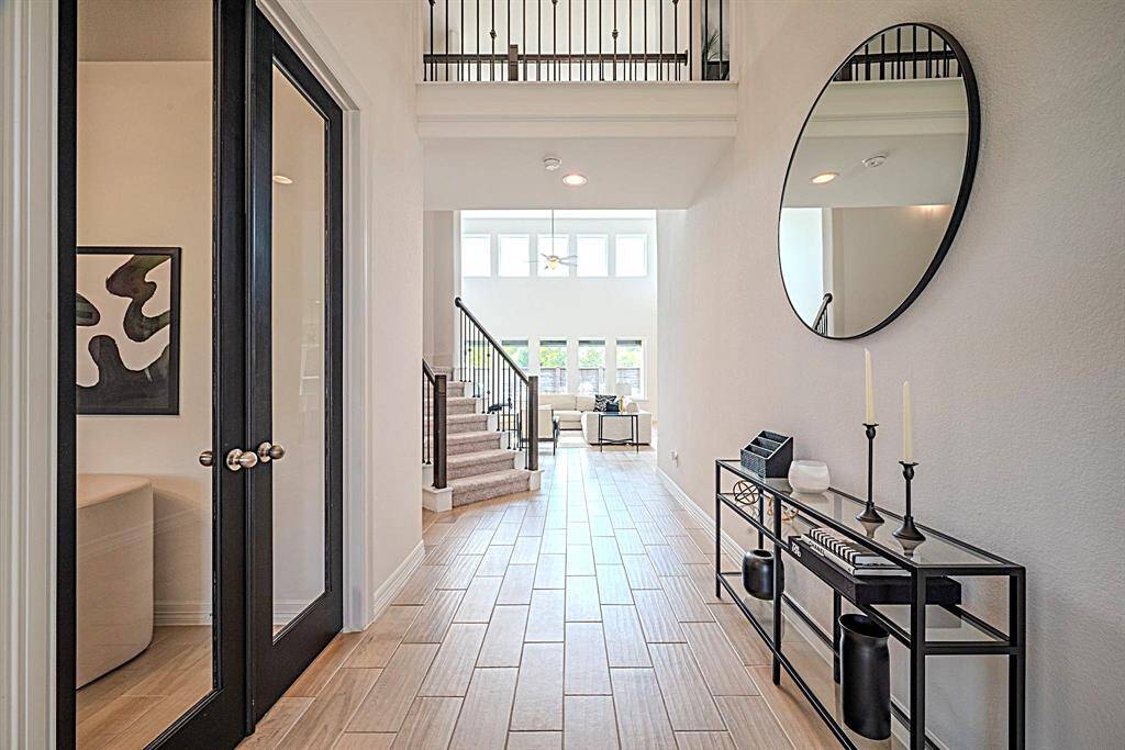 Designer features throughout, including this beautiful wood look tile flooring through living spaces