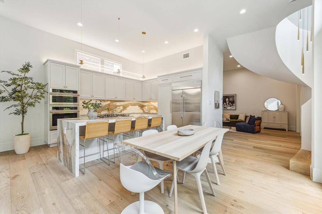 Another view of the dining room and kitchen.