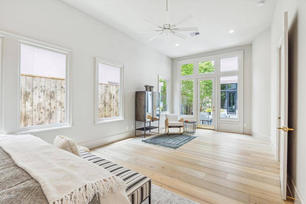 This sunlit suite features large-scale windows and French doors opening to the patio—perfect for indoor-outdoor living and effortless relaxation.