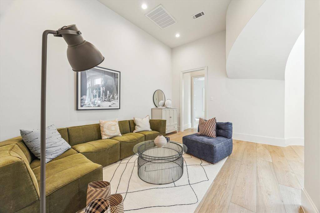 With soaring ceilings and a soft neutral palette, this flexible living space is ideal as a second den, library, or playroom.