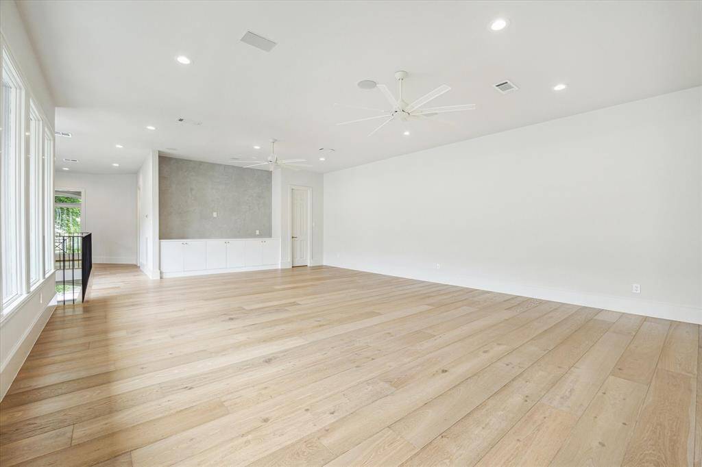 This expansive game room is the ultimate flex space—perfect for movie nights, playtime, or hosting guests.