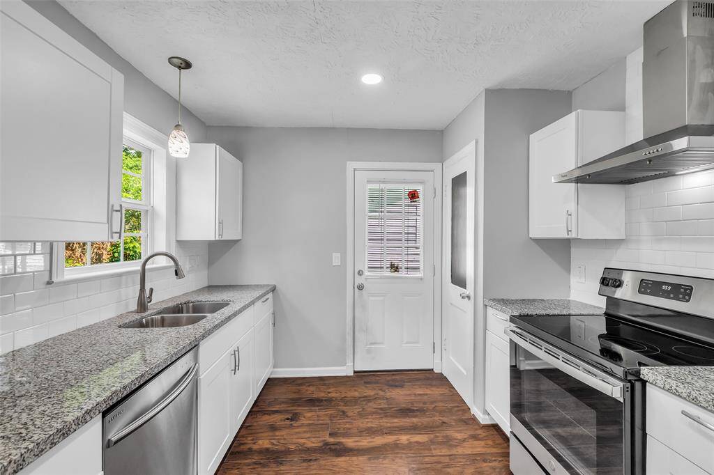 The kitchen is equipped with stainless steel appliances, including an electric cooktop, oven, dishwasher, microwave, and refrigerator, providing everything you need for convenient cooking and meal prep.