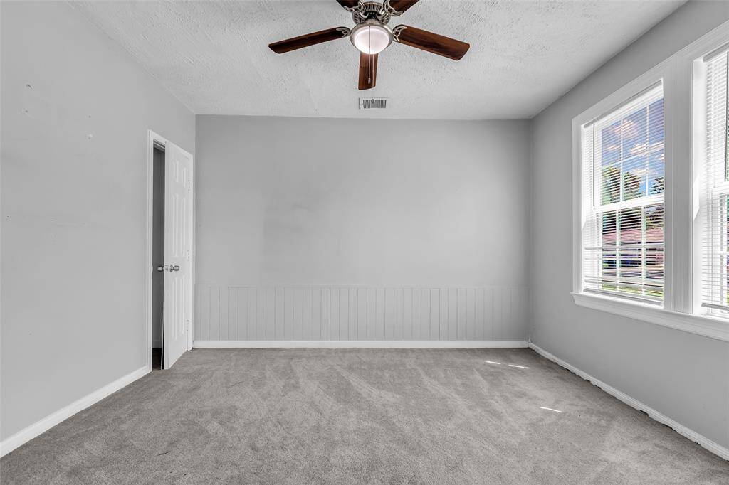 This main bedroom features large windows that fill the room with natural light, providing a versatile space for you to create your ideal bedroom.