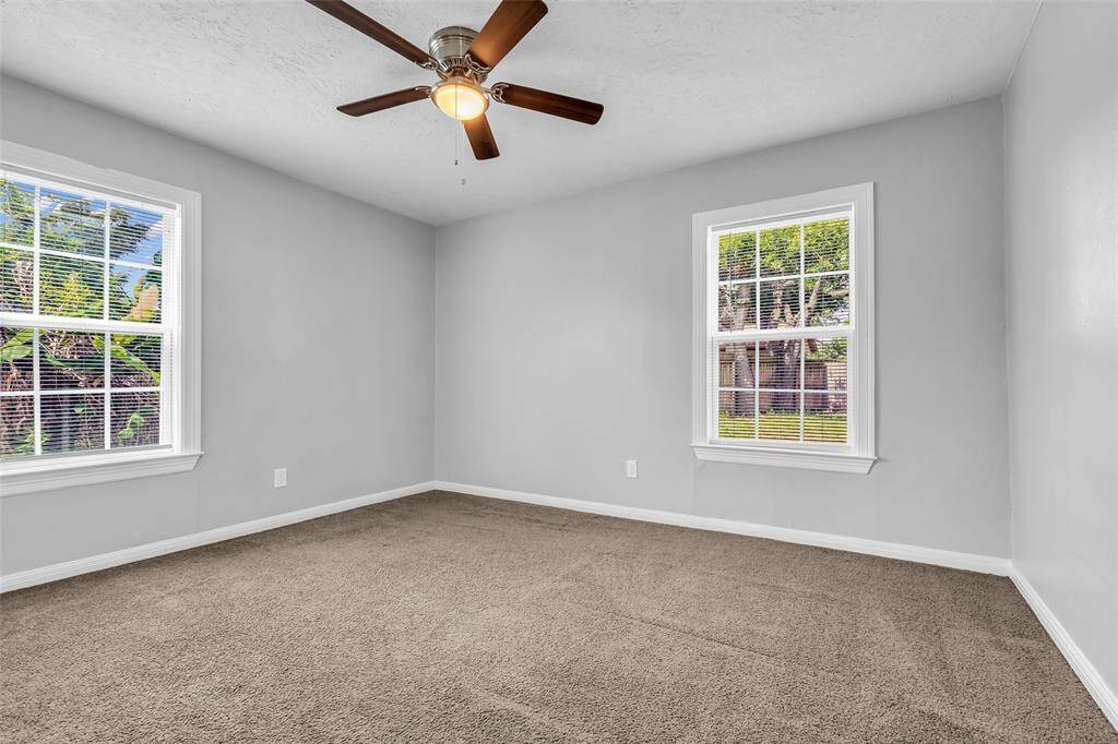 This secondary bedroom features carpeted floors and provides a blank canvas for you to arrange and personalize the space to your liking.