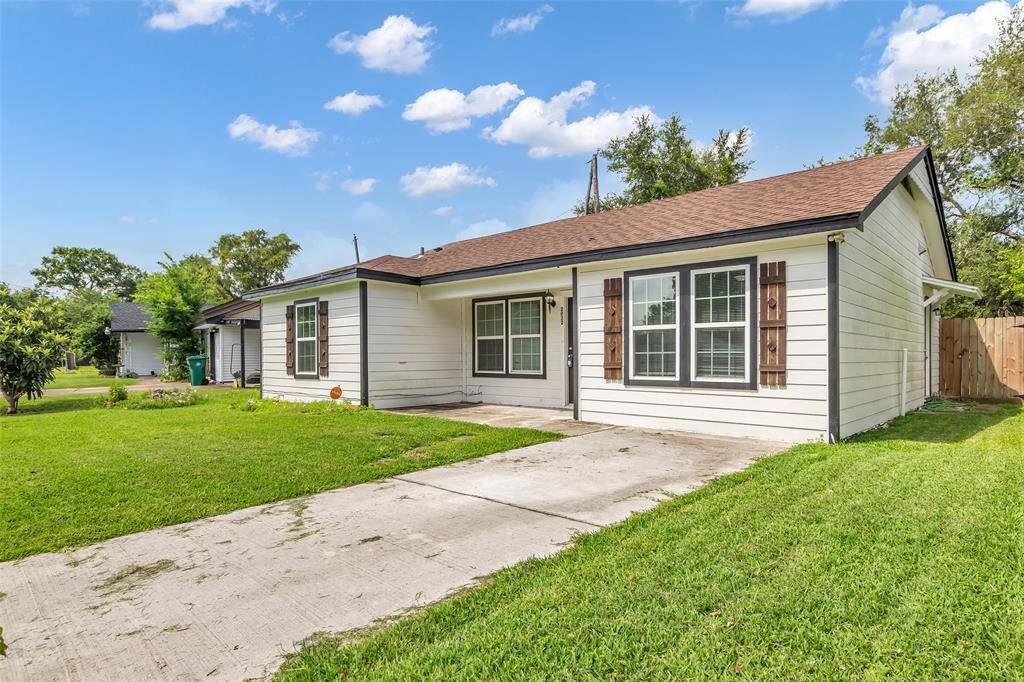 A view of the front lawn, complete with a private driveway that provides convenient access and parking.
