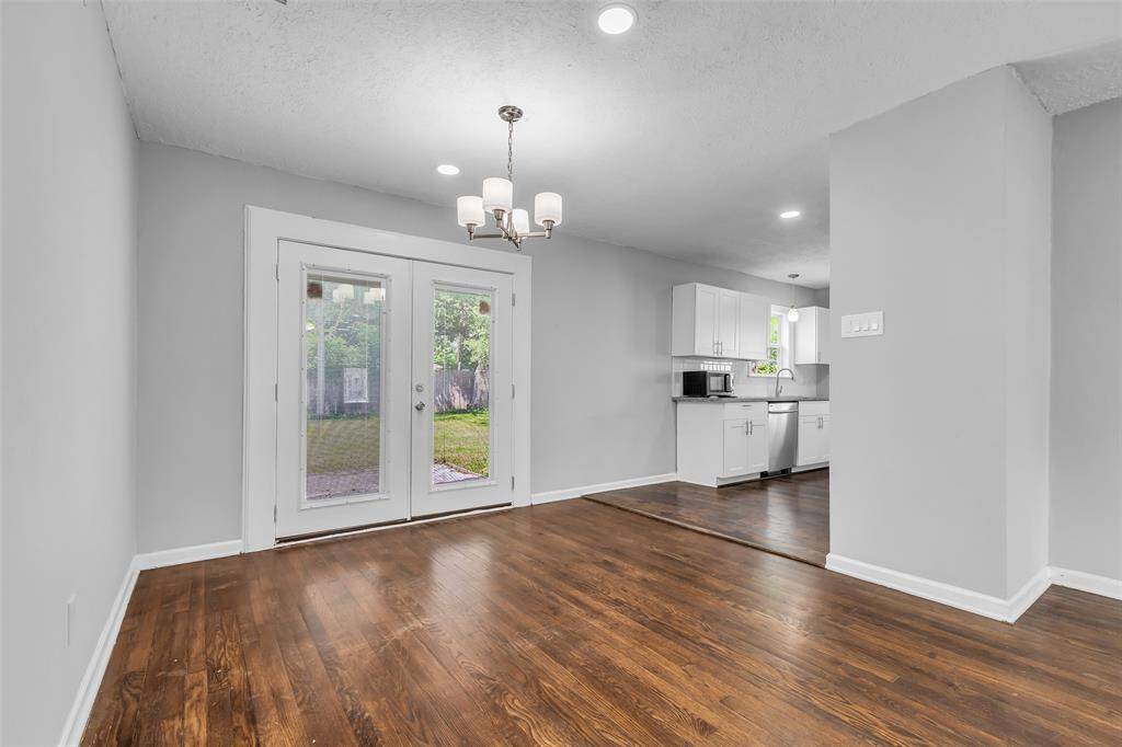 The dining area is situated near the end of the living room, just before the glass doors leading to the backyard. From here, you also get a partial view of the kitchen, creating a sense of connection between the spaces.
