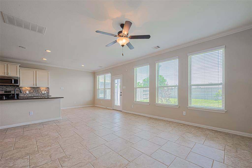 This wide-angle view reveals how effortlessly the living space flows into the kitchen and breakfast nook—perfect for everyday living and effortless entertaining.