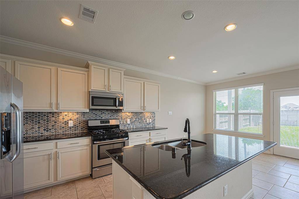 Tucked to the side of the kitchen, the breakfast area is bathed in light, creating the perfect spot to start the day with peaceful views and good company.