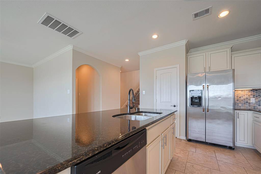 Under-cabinet storage on the island offers both utility and design continuity, seamlessly integrated into the kitchen’s clean lines.