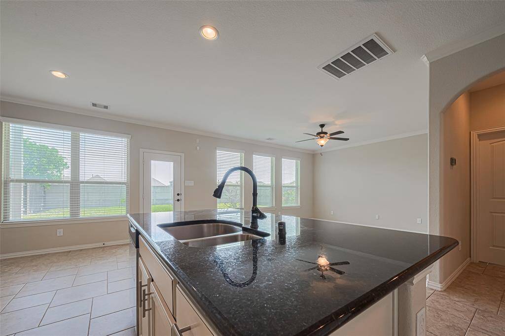 From the island, enjoy views of the outdoors, past the living area and wall of windows.